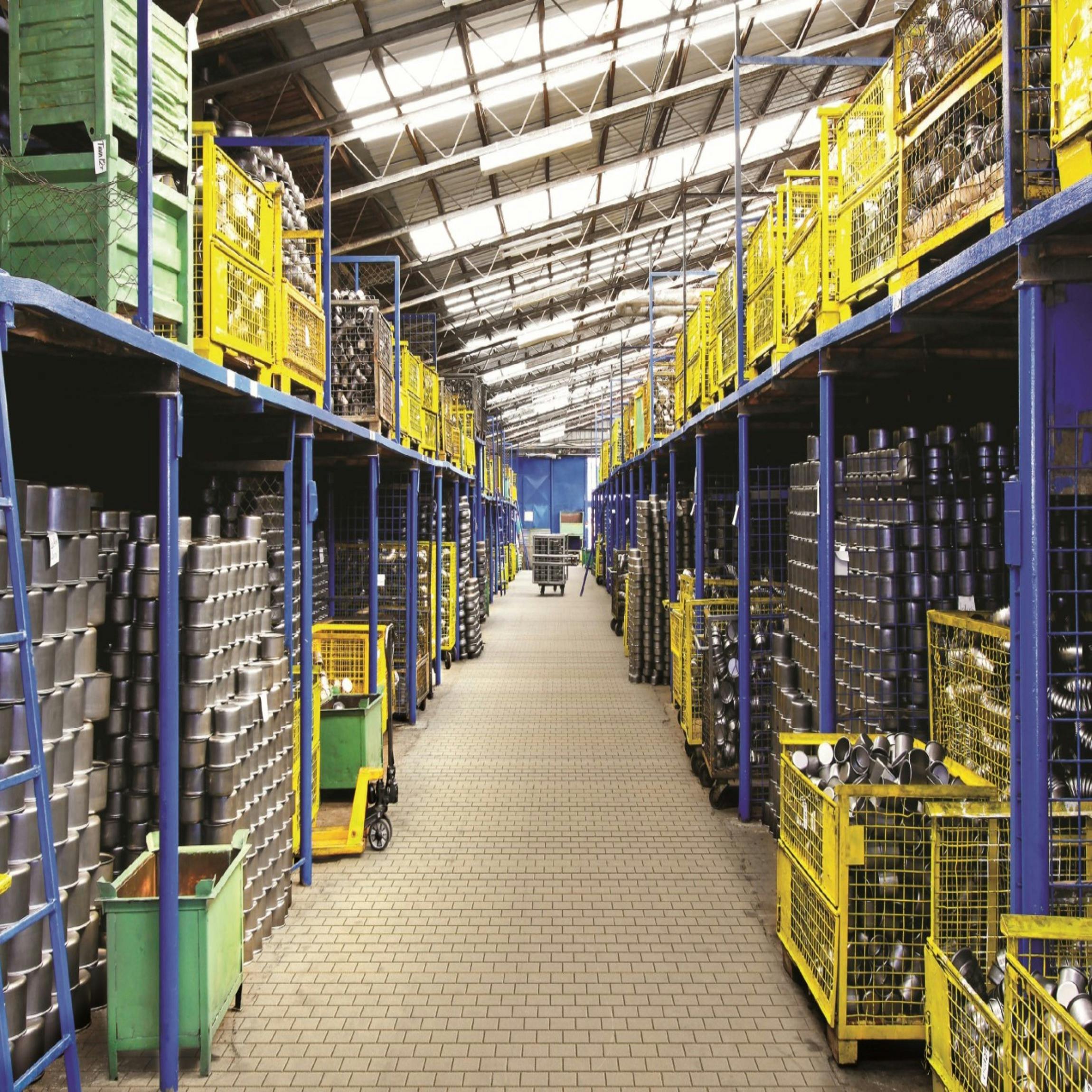 Warehouse aisle with pallets and logistics handling equipment.